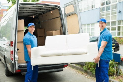 Student removals moving boxes in Canary Wharf high-rise apartment