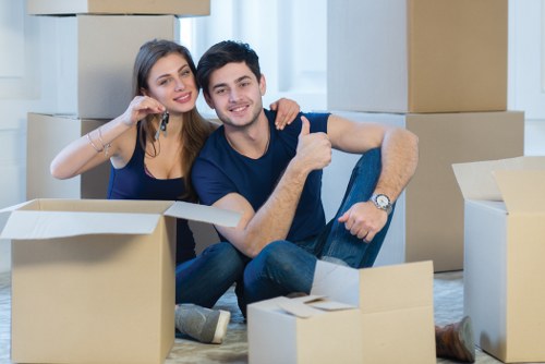 Removal company moving boxes in a Canary Wharf apartment setting