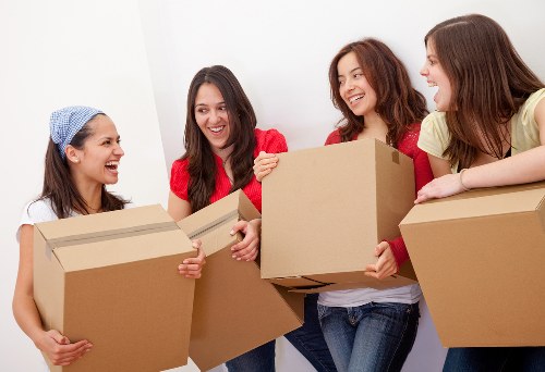 Packed moving boxes and furniture ready for transport by removal van in Canary Wharf